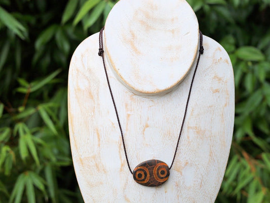 Brown Oval Flat 4 eyed Dzi Bead, Big Flat Barrel Vintage Tibetan Agate.  Overall, the four-eyed dzi bead is highly valued for its powerful protective energy and its ability to promote harmony,