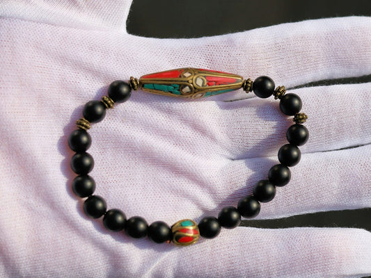 The Shaligram stones with Nepalese Brass beads from Nepal. Inlaid with turquoise and coral. Size : 25 x 10 mm