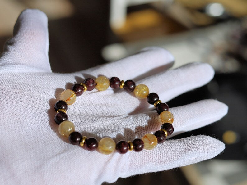 Red Garnet represents love with 10 mm Rutilated Quartz and Brass Spacer Beads. is known for its striking and beautiful appearance