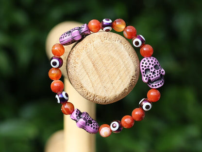 Crazy Lace Agate, EVIL EYE with Detailed, large resin bead: Skull. They can symbolize the acceptance of death as a natural part of life.