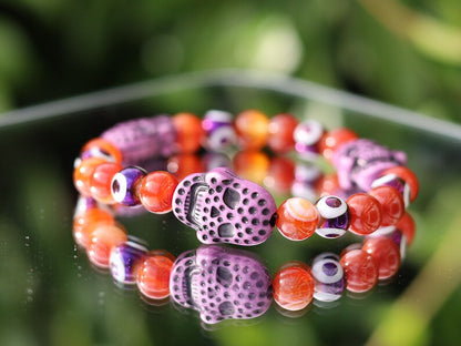 Crazy Lace Agate, EVIL EYE with Detailed, large resin bead: Skull. They can symbolize the acceptance of death as a natural part of life.