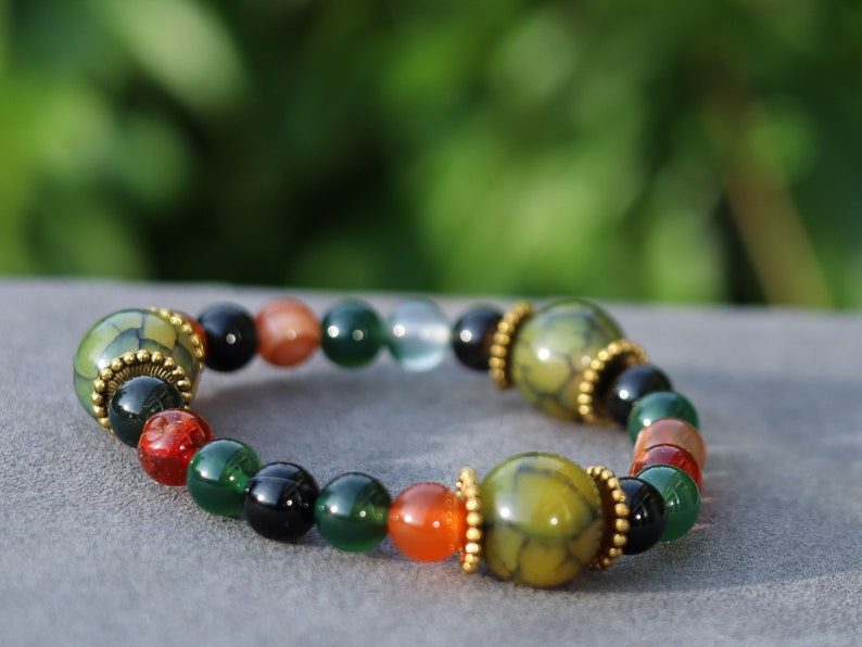 A mixed color agate beads bracelet with green/ black Dragon veins natural jade and Gold Plated Spacer Beads. the scales or veins of a dragon