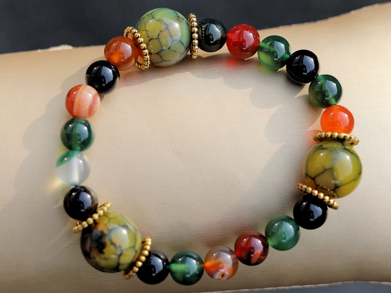 A mixed color agate beads bracelet with green/ black Dragon veins natural jade and Gold Plated Spacer Beads. the scales or veins of a dragon