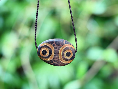 Brown Oval Flat 4 eyed Dzi Bead, Big Flat Barrel Vintage Tibetan Agate.  Overall, the four-eyed dzi bead is highly valued for its powerful protective energy and its ability to promote harmony,