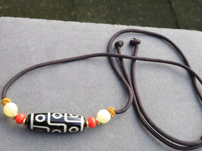 Black white Carnelian Onyx DZI nine bead Agate Stone Choker, with an adjustable necklace with a slide knot.  Features red and  yellow beads.
