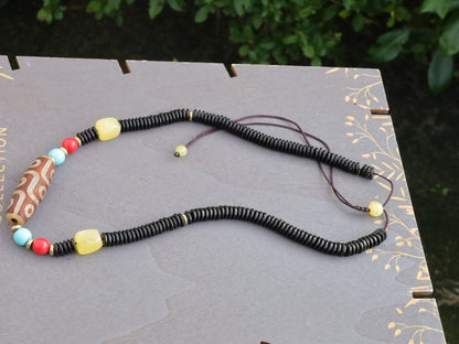 Carnelian Onyx DZI nine bead Agate Stone Choker, with an adjustable necklace with a slide knot. Features red, turquoise,yellow spacer beads.