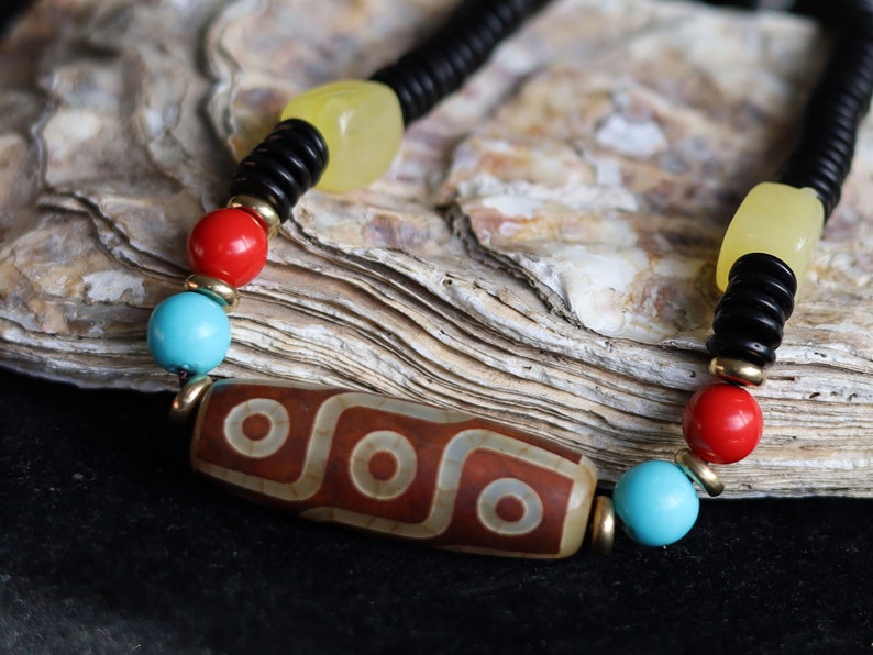 Carnelian Onyx DZI nine bead Agate Stone Choker, with an adjustable necklace with a slide knot. Features red, turquoise,yellow spacer beads.