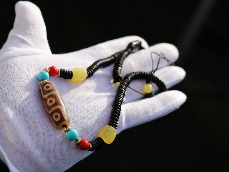 Carnelian Onyx DZI nine bead Agate Stone Choker, with an adjustable necklace with a slide knot. Features red, turquoise,yellow spacer beads.