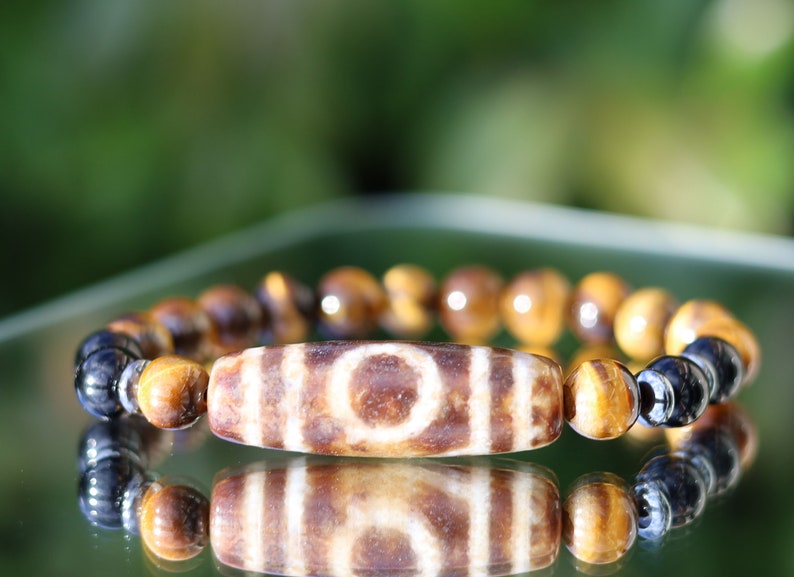Old one eyed Dzi  bead Tiger eye bracelet with Black agate.These beads are believed to bring spiritual benefits and protection to the wearer