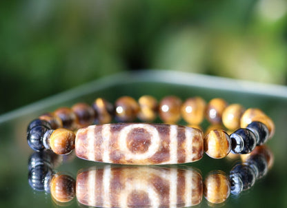 Old one eyed Dzi  bead Tiger eye bracelet with Black agate.These beads are believed to bring spiritual benefits and protection to the wearer