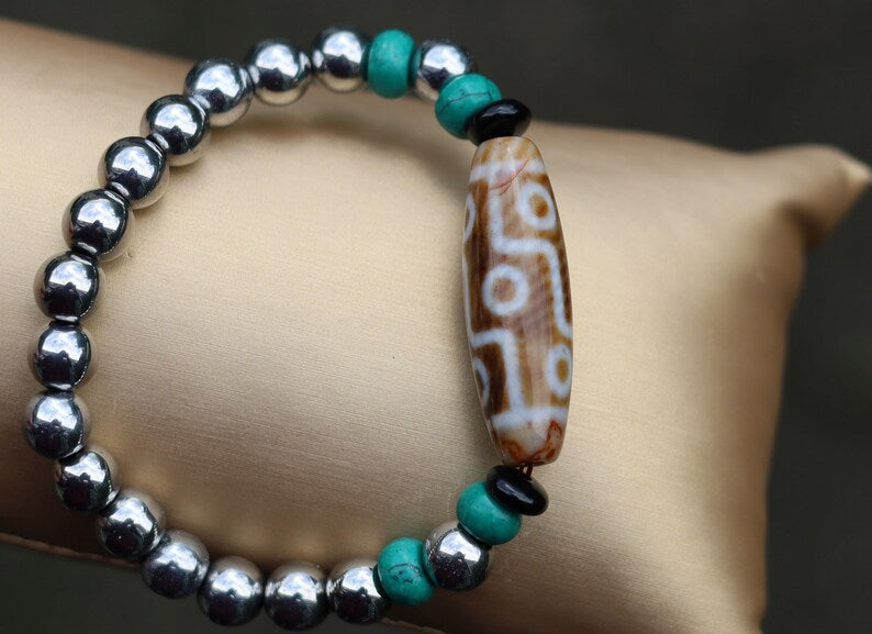 Old nine eyed Dzi  bead The Hematite crystal bracelet with Tibetan turquoise buddhist prayer beads.  capability to control life