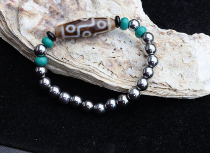 Old nine eyed Dzi  bead The Hematite crystal bracelet with Tibetan turquoise buddhist prayer beads.  capability to control life