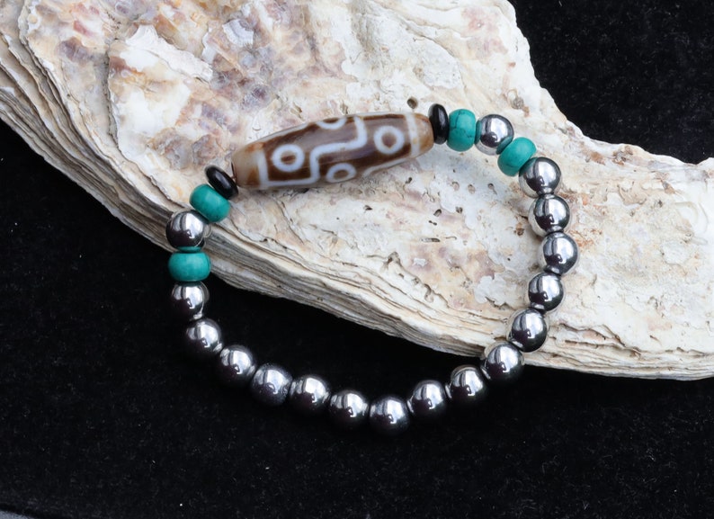 Old nine eyed Dzi  bead The Hematite crystal bracelet with Tibetan turquoise buddhist prayer beads.  capability to control life