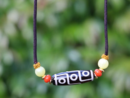 Black white Carnelian Onyx DZI nine bead Agate Stone Choker, with an adjustable necklace with a slide knot.  Features red and  yellow beads.