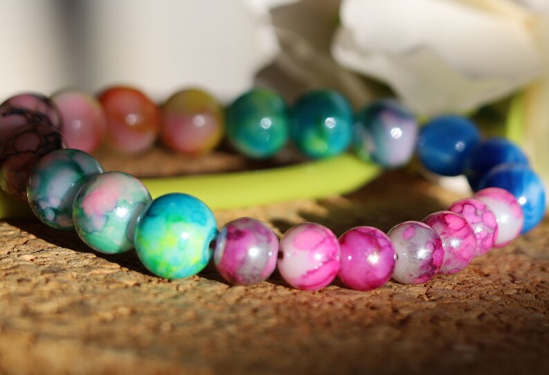 Flashy bracelets Pieces of beautiful mixed color amazing glass beads and holographic beads.is often associated with transparency, clarity