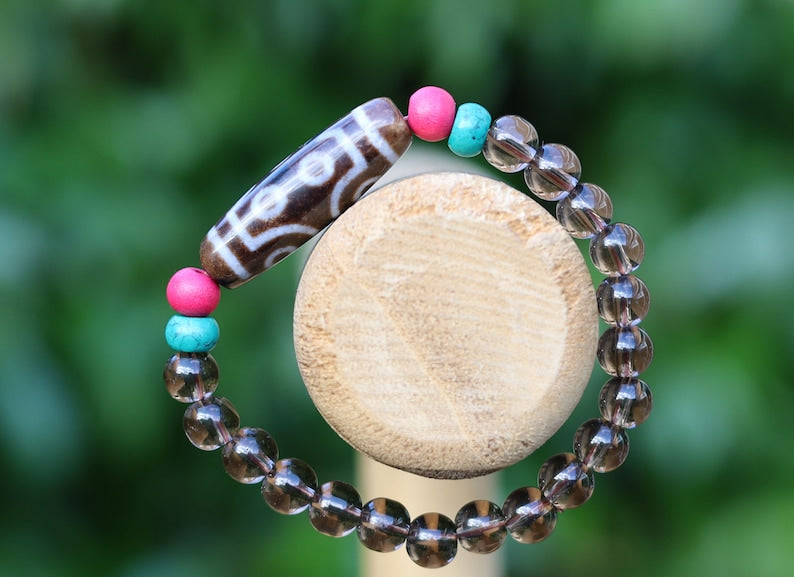 Old  Seven-eye dZi bead Smoky Quartz bracelet with Howlite Beads with engraved Buddhist Tibetan decoration and Dark pink roundel. Dzi bead