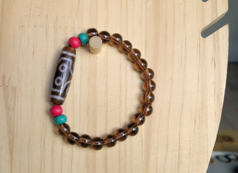 Old  Seven-eye dZi bead Smoky Quartz bracelet with Howlite Beads with engraved Buddhist Tibetan decoration and Dark pink roundel. Dzi bead