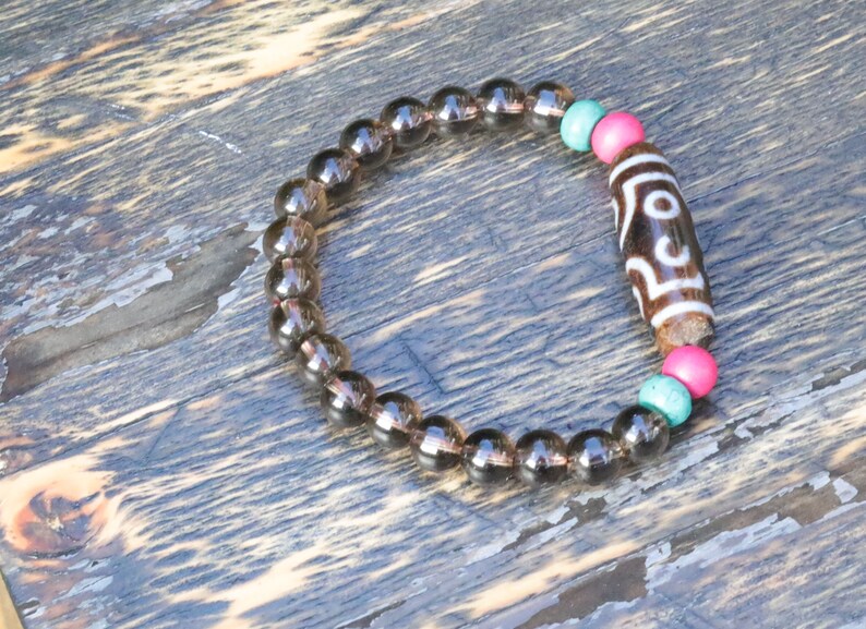 Old  Seven-eye dZi bead Smoky Quartz bracelet with Howlite Beads with engraved Buddhist Tibetan decoration and Dark pink roundel. Dzi bead