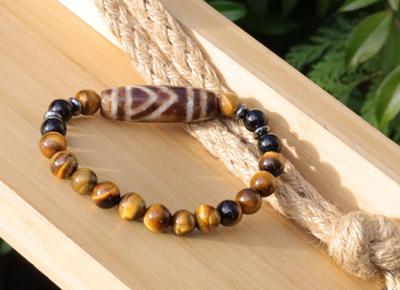 Old one eyed Dzi  bead Tiger eye bracelet with Black agate.These beads are believed to bring spiritual benefits and protection to the wearer