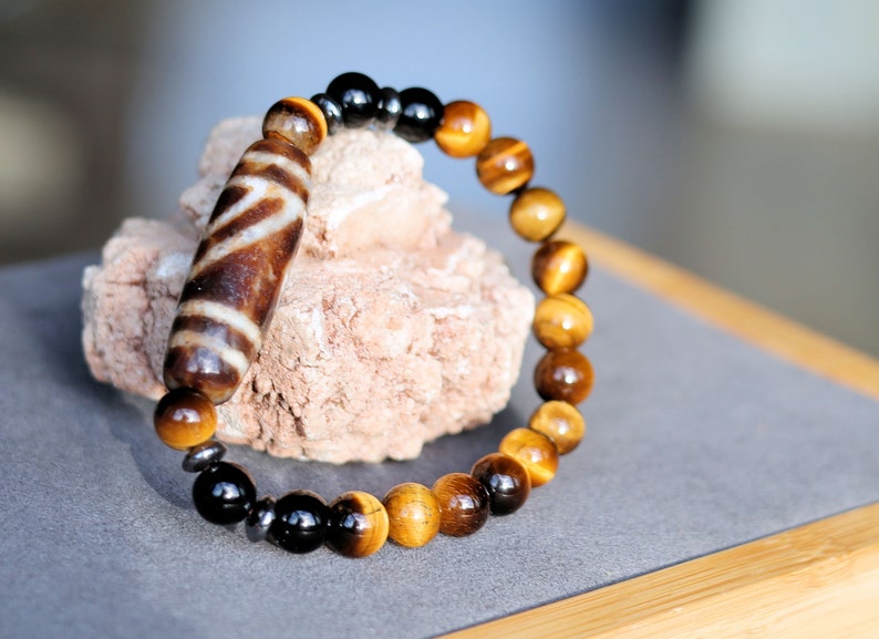 Old one eyed Dzi  bead Tiger eye bracelet with Black agate.These beads are believed to bring spiritual benefits and protection to the wearer