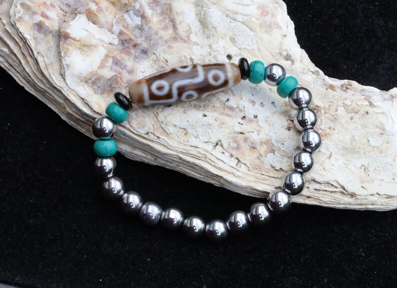 Old nine eyed Dzi  bead The Hematite crystal bracelet with Tibetan turquoise buddhist prayer beads.  capability to control life