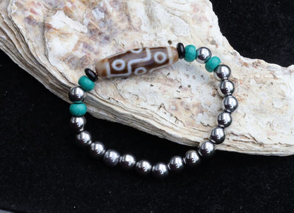 Old nine eyed Dzi  bead The Hematite crystal bracelet with Tibetan turquoise buddhist prayer beads.  capability to control life