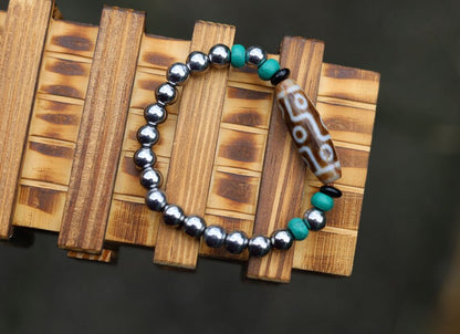 Old nine eyed Dzi  bead The Hematite crystal bracelet with Tibetan turquoise buddhist prayer beads.  capability to control life
