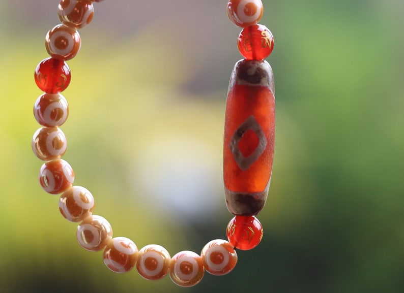 Old Two-eye Dzi  bead bracelet with Electroplate Glass Beads , Round with Evil Eye Pattern,Orange. unblock the path to enlightenment.