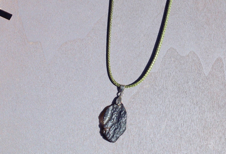 Our Indochinite Black Tektite Thailand Pendant is here to elevate your spiritual journey to new heights