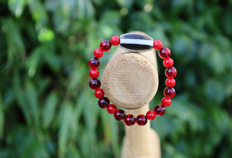 One of a kind Mexico red blood beeswax beads Certified 8mm. Combined with Crimson Burst Flower Stone and  Mother of Pearl Black.