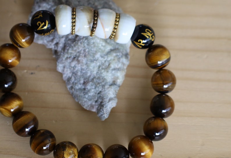 Large Apple Shell Heishi beads with large Apple Shell Heishi beads beads and 10mm Tiger eye.  into a state of calm aiding