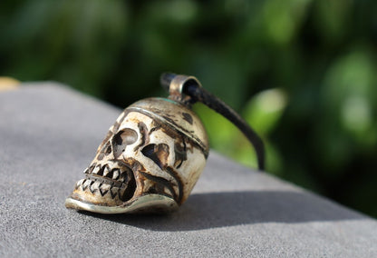 A bone skull amulet or pendant with metal mounting that originates from Nepal can hold various meanings and cultural significance.