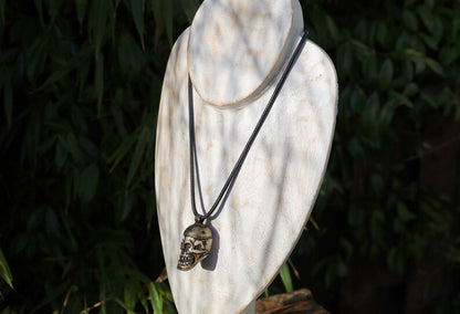 A bone skull amulet or pendant with metal mounting that originates from Nepal can hold various meanings and cultural significance.