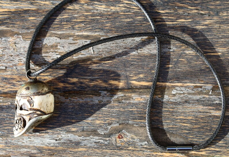 A bone skull amulet or pendant with metal mounting that originates from Nepal can hold various meanings and cultural significance.