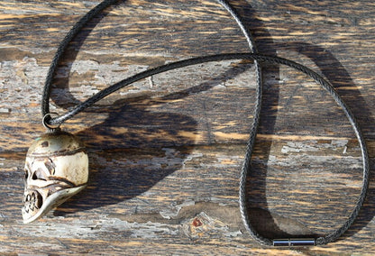 A bone skull amulet or pendant with metal mounting that originates from Nepal can hold various meanings and cultural significance.