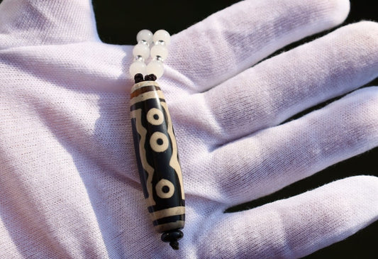 Double Tiger Tooth, or Tasso pendant necklace.  It is also revered as a spiritual object, capable of keeping away evil things