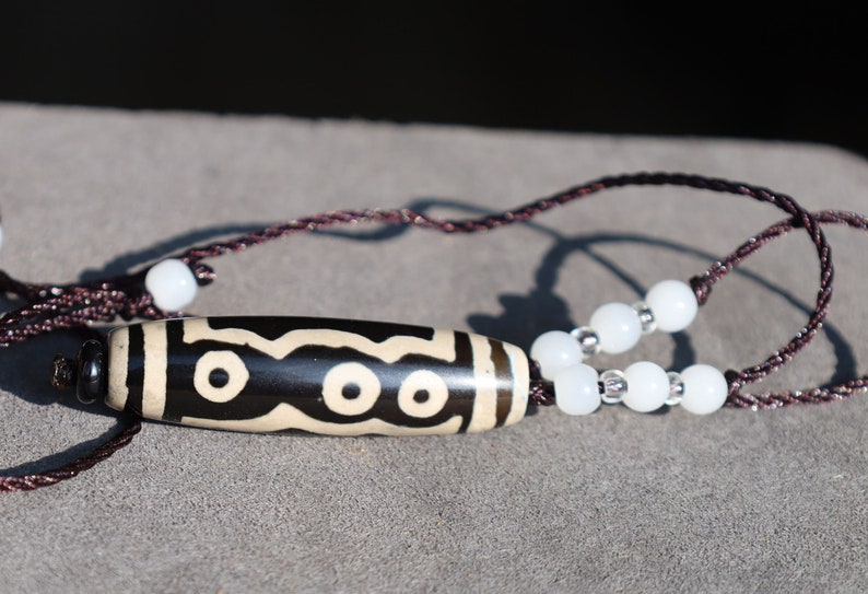 Double Tiger Tooth, or Tasso pendant necklace.  It is also revered as a spiritual object, capable of keeping away evil things