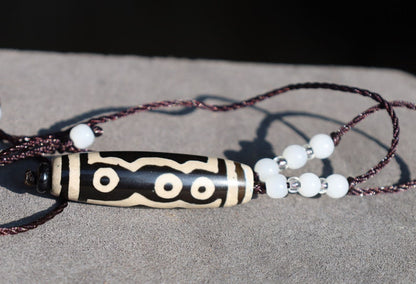 Double Tiger Tooth, or Tasso pendant necklace.  It is also revered as a spiritual object, capable of keeping away evil things