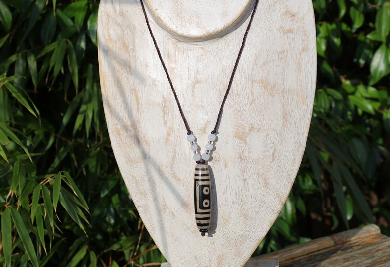 Double Tiger Tooth, or Tasso pendant necklace.  It is also revered as a spiritual object, capable of keeping away evil things
