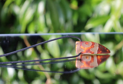 Three-eye Crescent Dzi Beads pendant necklace. In Buddhism the bead symbolizes the god of wealth Yellow Dzambala (Kubera)
