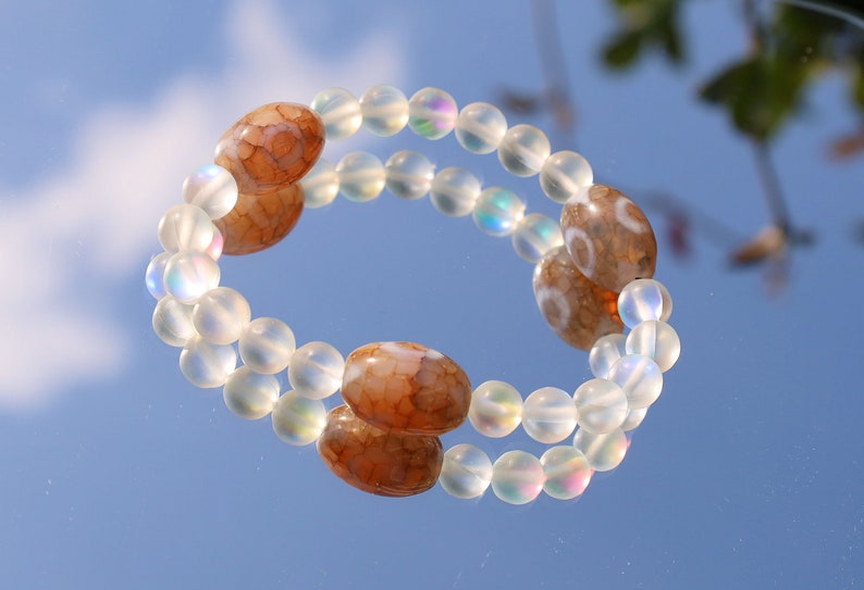 Three Dzi  barrel bead Agate bracelet with Matte Aurora Crystal Glass Beads," also known as "Frosted Mystic Aura Mermaid Beads