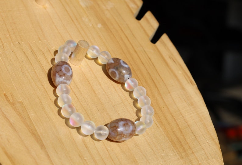 Three Dzi  barrel bead Agate bracelet with Matte Aurora Crystal Glass Beads," also known as "Frosted Mystic Aura Mermaid Beads
