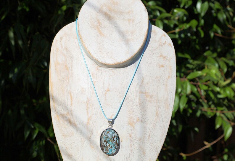 Copper Mohave Larimar  925, silver plated pendant.  Copper Mohave Larimar is a unique and visually striking stone that combines the serene qualities of Larimar with the conductive and enhancing properties of copper