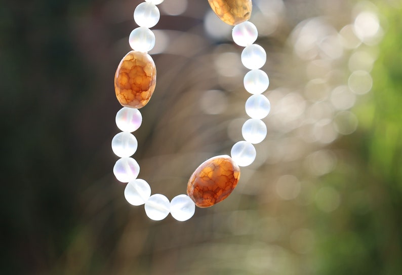 Three Dzi  barrel bead Agate bracelet with Matte Aurora Crystal Glass Beads," also known as "Frosted Mystic Aura Mermaid Beads