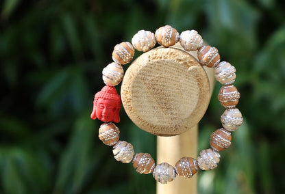 Beautiful large, handcrafted bead of real red Cinnabar Buddha. With repoussé beads brown and creme.