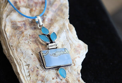 Owhyee Blue Opal and Blue Chalcedony   925 Silver Plated Handmade Pendant   Owyhee Blue Opal and Blue Chalcedony are both serene, blue-colored gemstones that exude calm and soothing energies