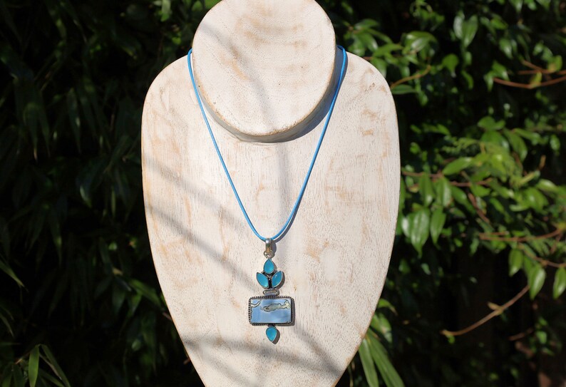 Owhyee Blue Opal and Blue Chalcedony   925 Silver Plated Handmade Pendant   Owyhee Blue Opal and Blue Chalcedony are both serene, blue-colored gemstones that exude calm and soothing energies