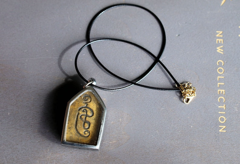 The Kun Peng+Ku Man Tong amulet represents a unique blend of Thai spiritual traditions, combining aspects of two distinct types