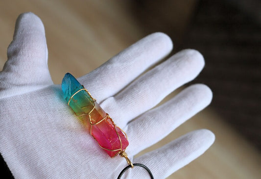 A Quartz Crystal Rainbow Stone pendant encompasses the natural beauty and energetic properties of quartz crystal