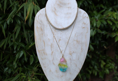 Colorful Quartz Crystal Rainbow Stone Wire Wrapped Crystal Pendant  A Quartz Crystal Rainbow Stone pendant encompasses the natural beauty and energetic properties of quartz crystal